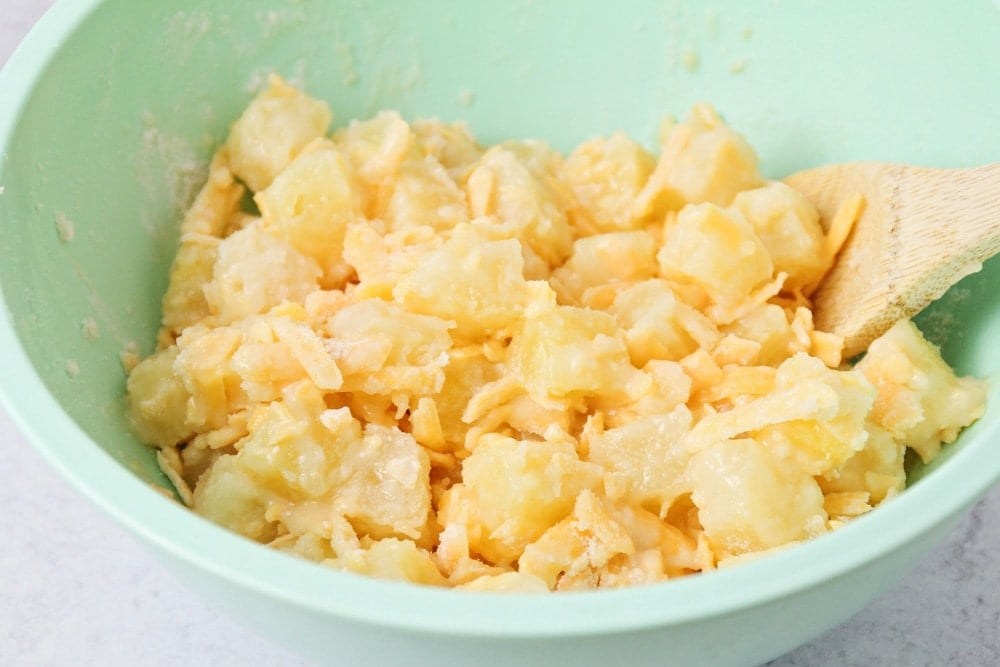Ingredients for pineapple casserole mixed in a bowl.