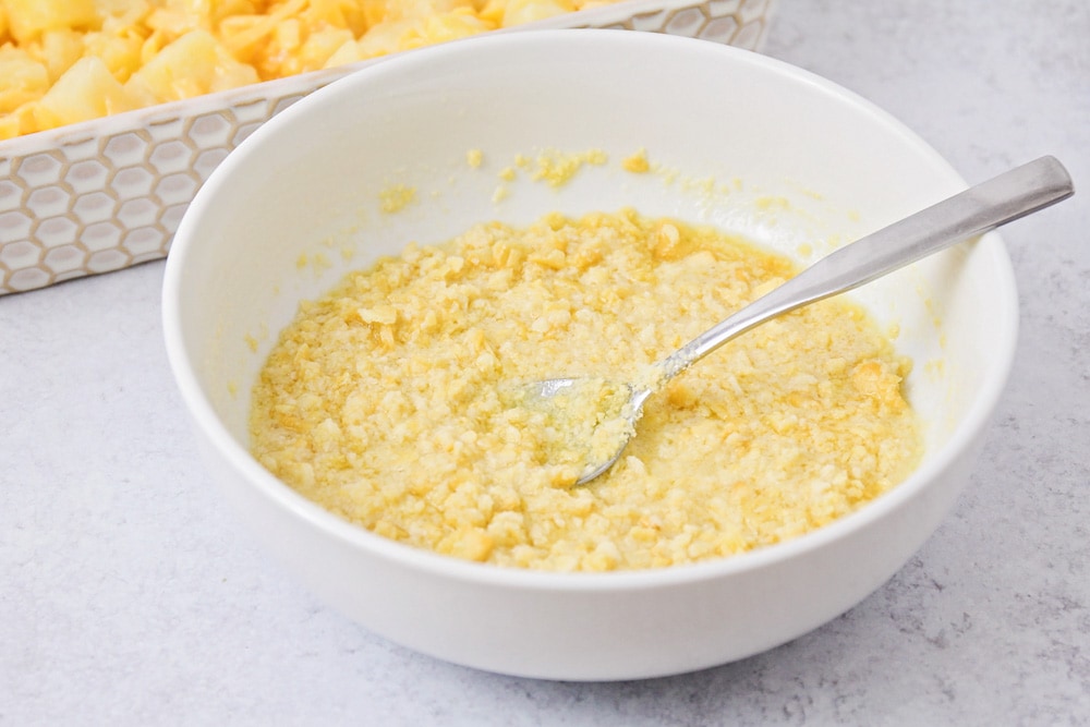 Cracker topping for pineapple casserole recipe in white bowl.