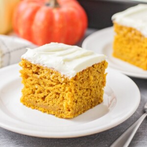 Slice of pumpkin cake on a white plate.