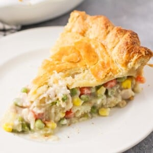 A slice of turkey pot pie on a white plate.