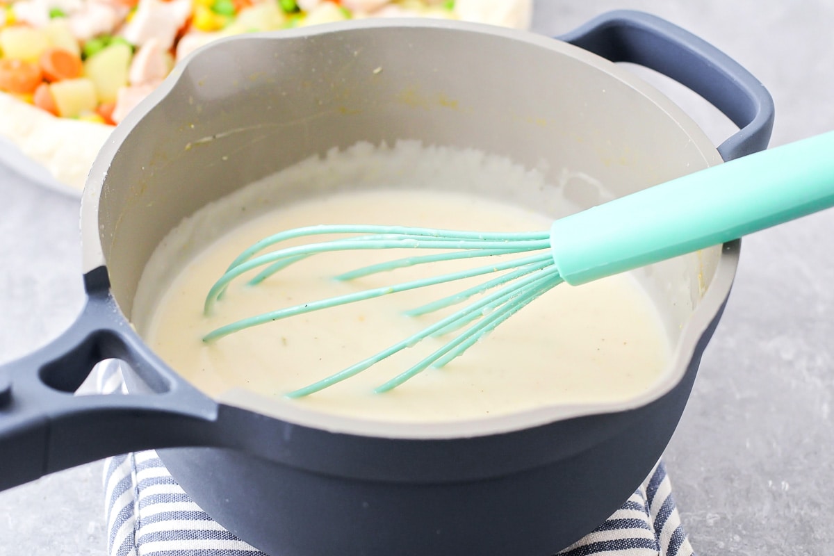 A pot filled with creamy gravy.