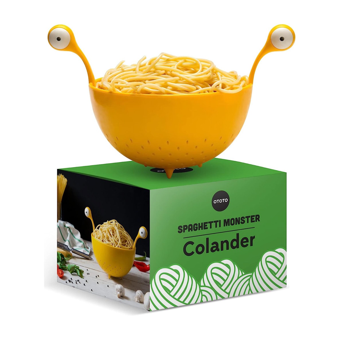 A yellow colander with monster eyes full of cooked spaghetti.