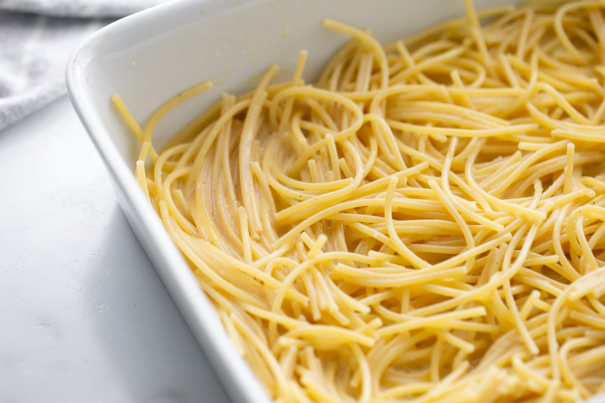 Spaghetti noodles in baking dish.