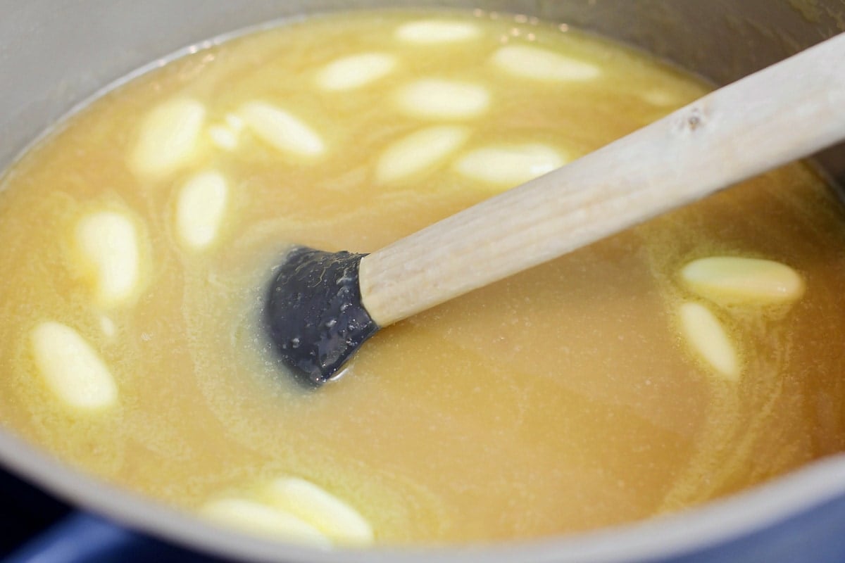 Melting butter in a pot on the stove.