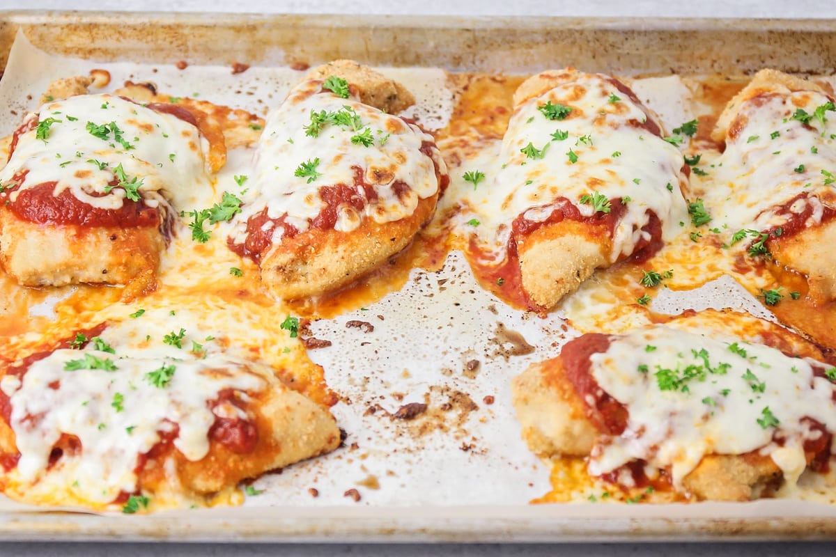 Crispy chicken breasts baked with mozzarella and topped with fresh parsley.