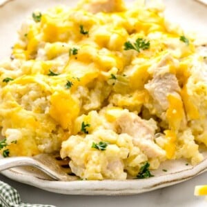 A serving of chicken and rice casserole on a white plate.