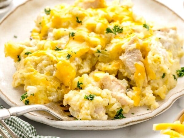 A serving of chicken and rice casserole on a white plate.