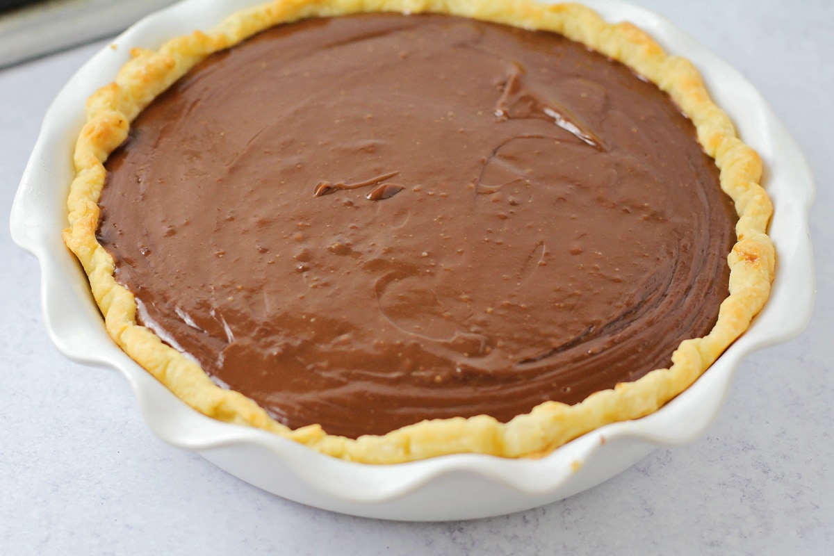 A pie crust filled with chocolate custard.