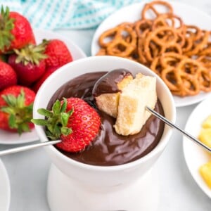 Chocolate fondue with strawberry and pound cake dipped into it.