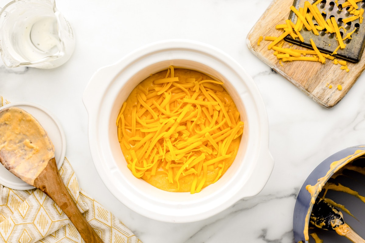Dip in a crock pot topped with shredded cheese.