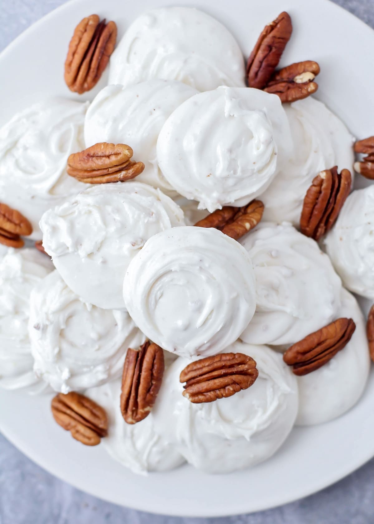 Close up of a plate filled with divinity recipe with pecans.