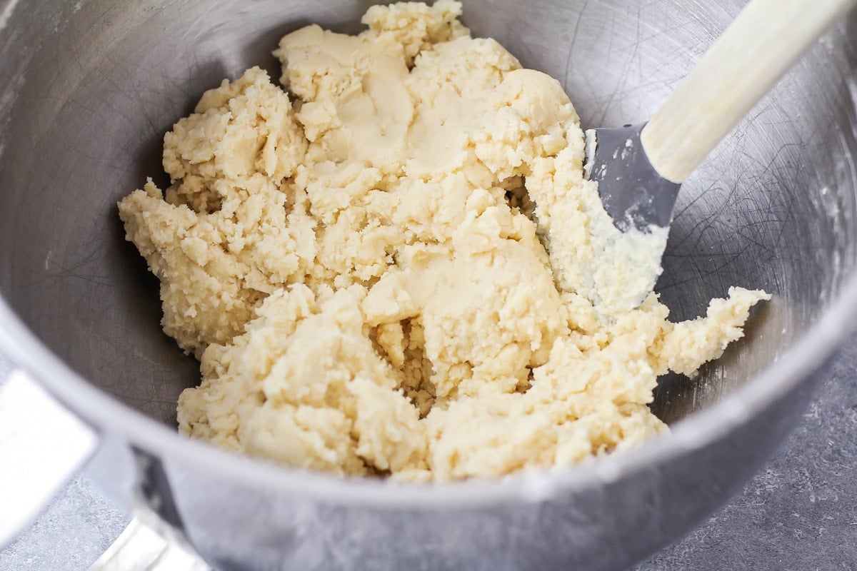 A metal bowl filled with sugar cookie dough.