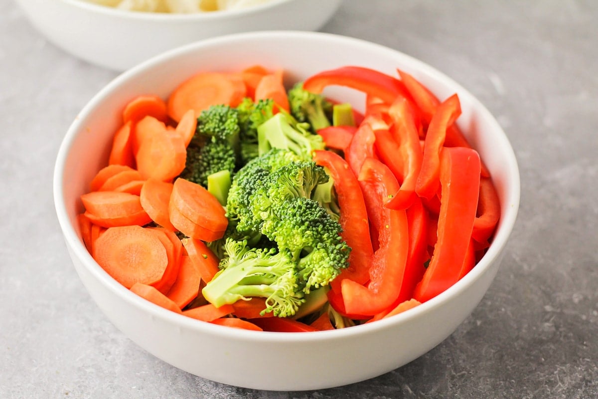 Close up of white bowl filled with veggies.