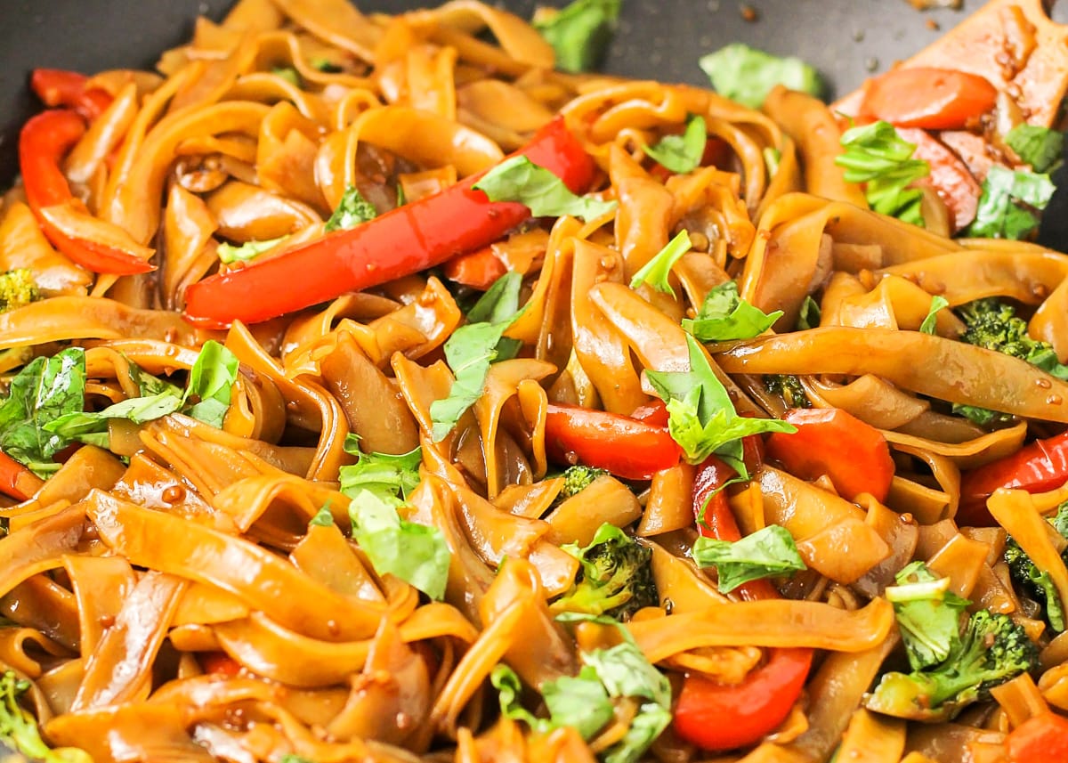 Close up of drunken noodles cooked in a wok on the stove.