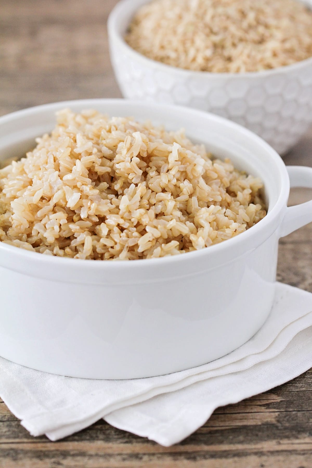 Close up of a white bowl of instant pot brown rice.