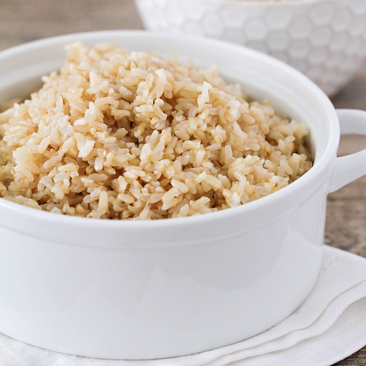 Close up of a white bowl filled with instant pot brown rice.