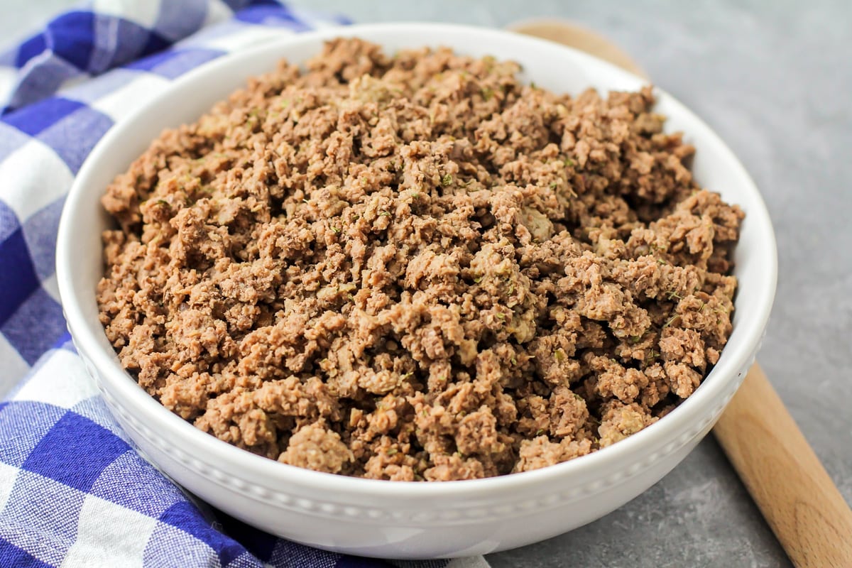 Cooked ground beef in a white serving bowl.