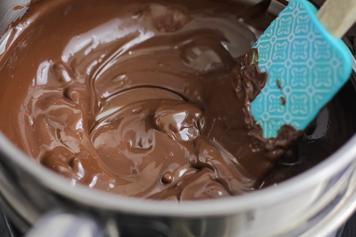 Dark chocolate wafers melting in a double boiler.