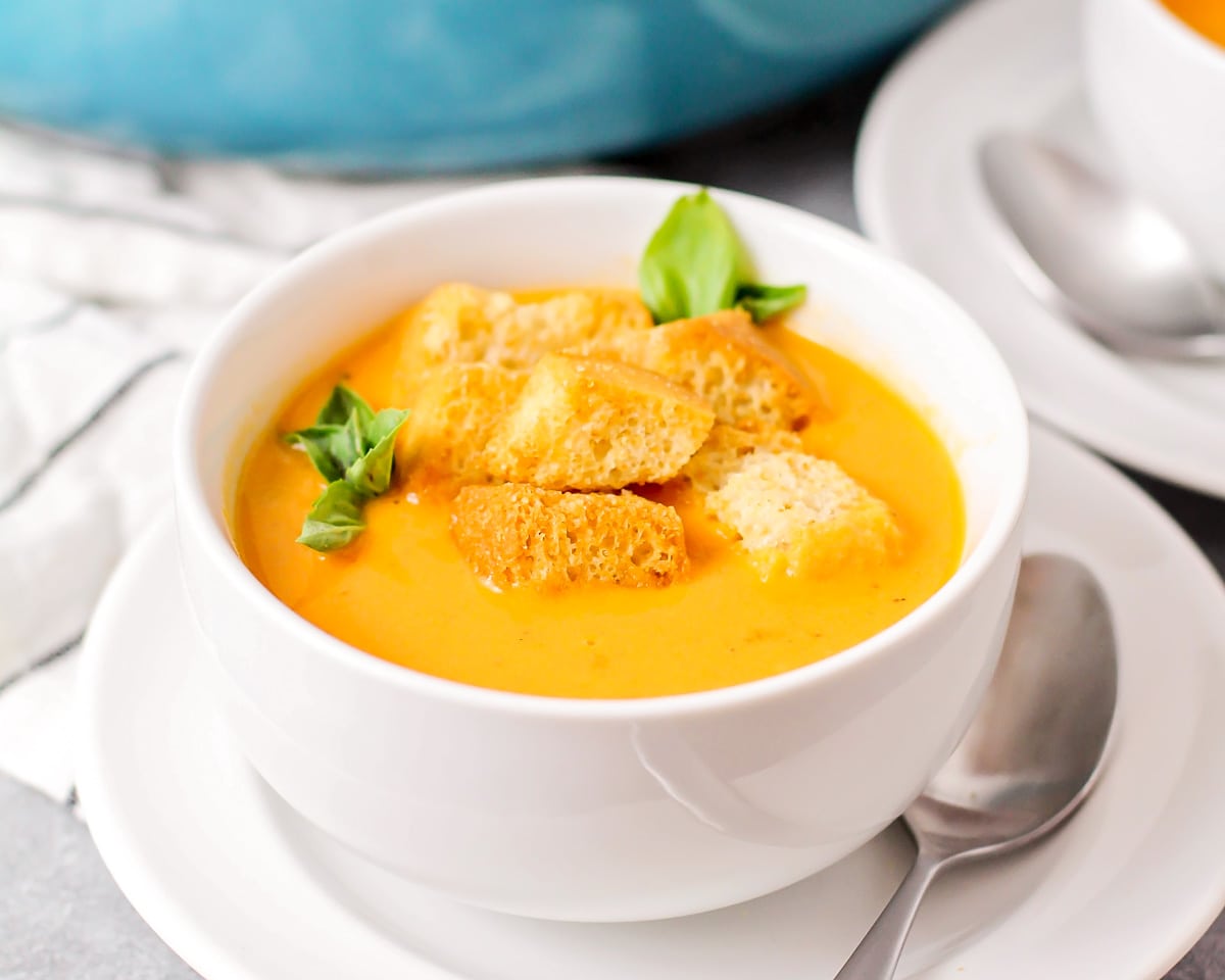 A bowl of roasted butternut squash soup topped with croutons.