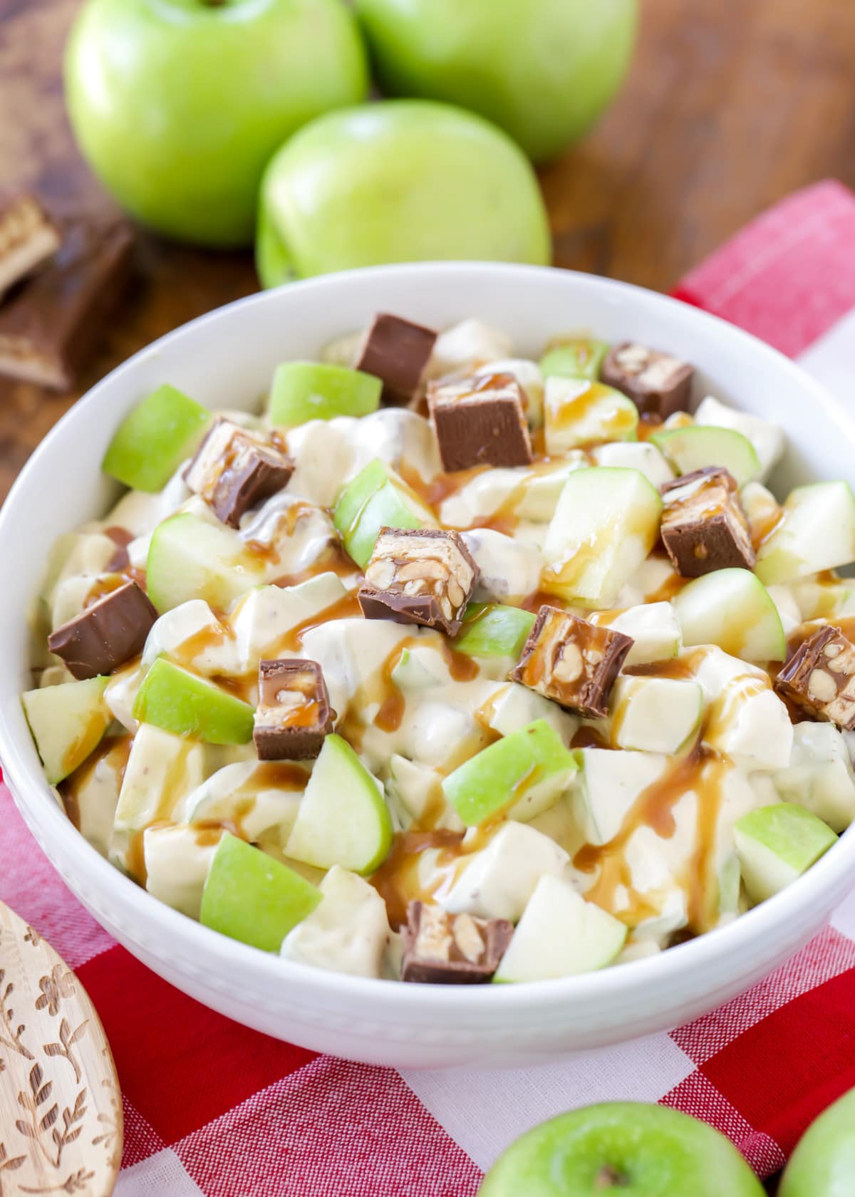 A white bowl filled with snicker apple salad.