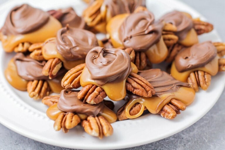 Homemade Turtles Candy recipe - stacked on top of each other on white plate.
