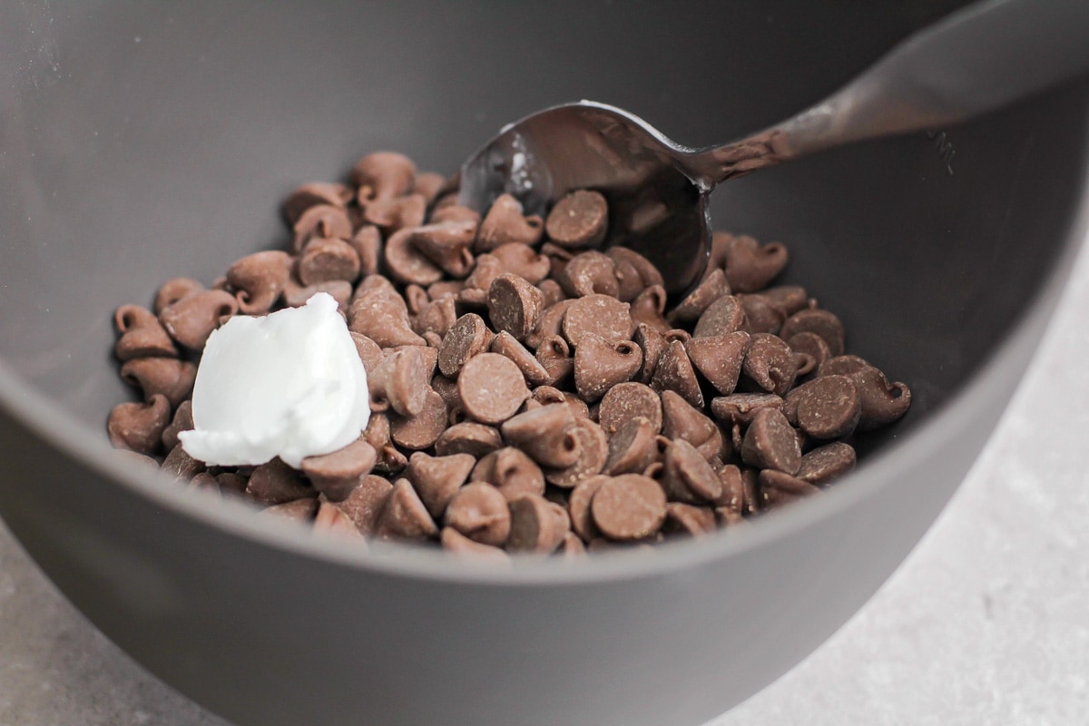 Chocolate chips in a grey bowl.