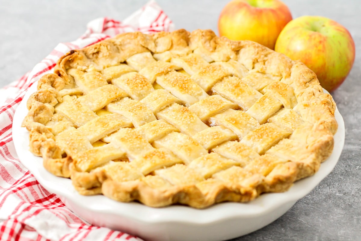 A fresh baked apple pie recipe in a white pie pan.