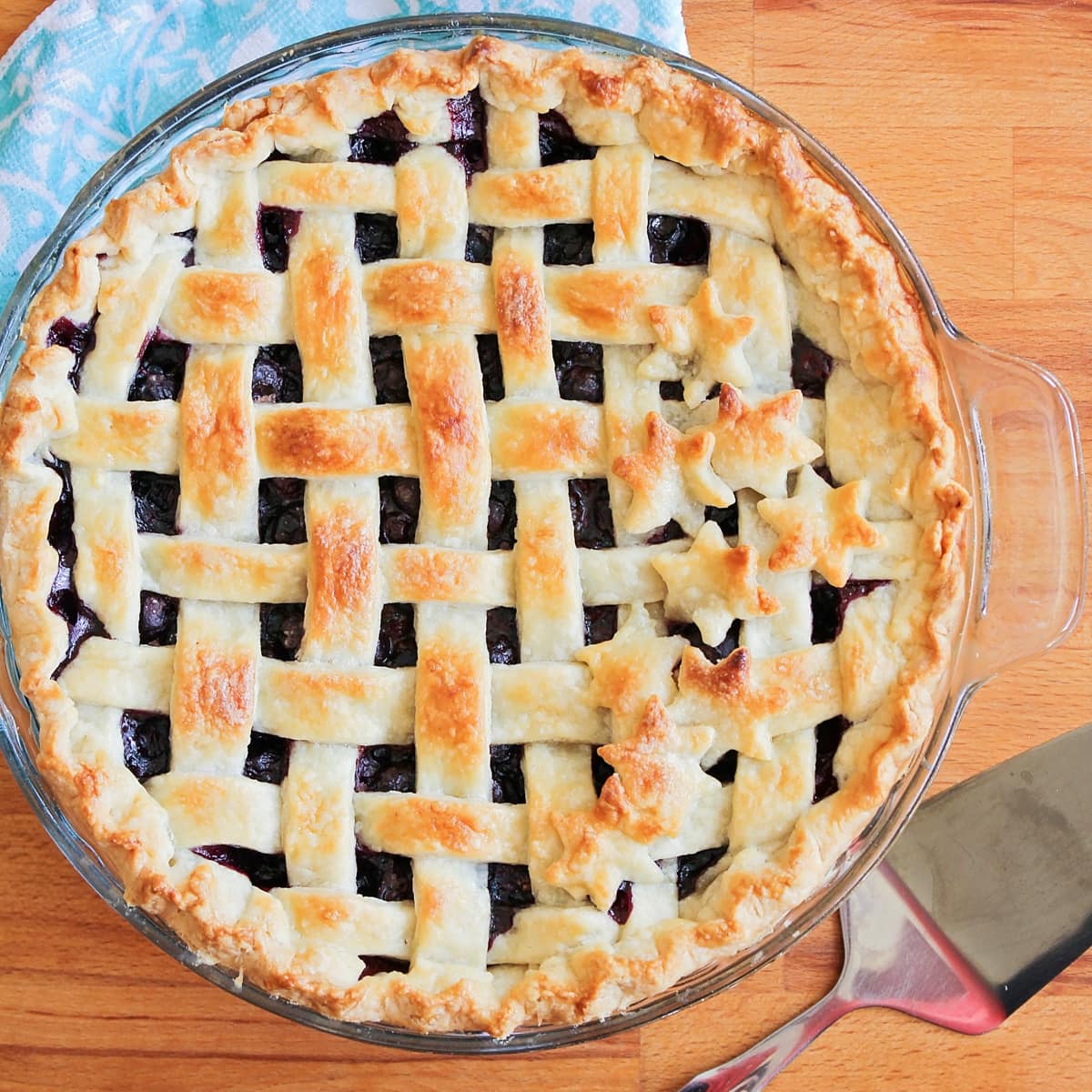 Top view of a fresh blueberry pie with a lattice crust.