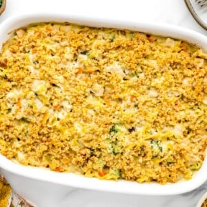 Chicken noodle casserole baked in a white baking dish.