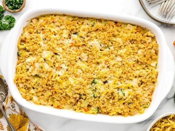 Chicken noodle casserole baked in a white baking dish.
