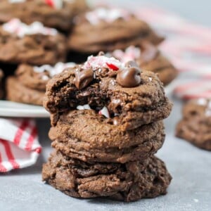Stacked chocolate peppermint cookies with one bite missing.