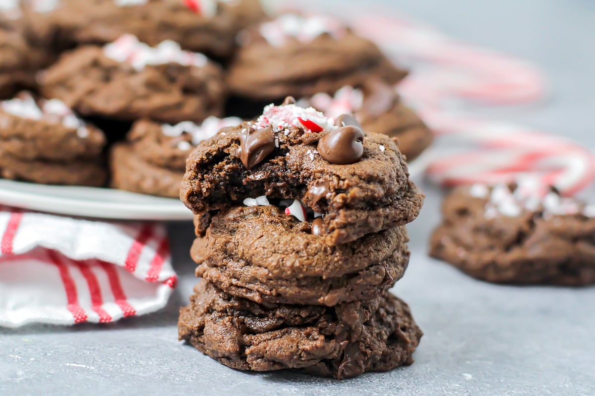 A stack of chocolate peppermint cookies with one bite missing.