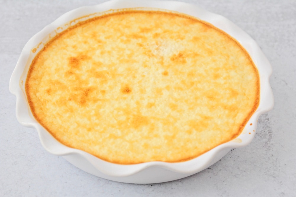 Baked flan in a white dish.