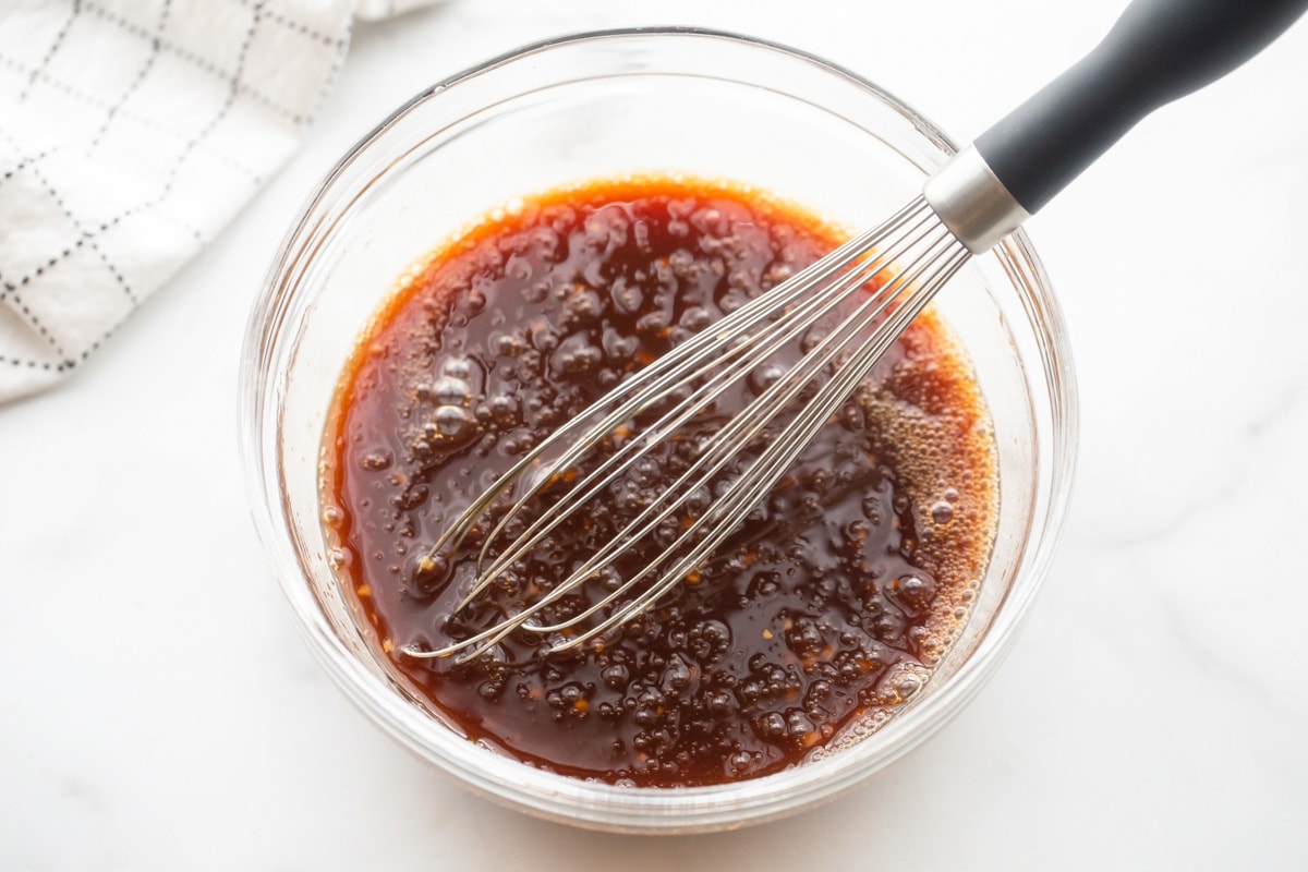 Marinade whisked in a glass bowl.