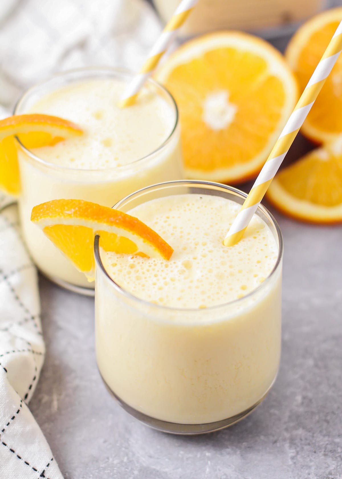 Close up of Orange Julius recipe in a glass with a slice of fresh orange.