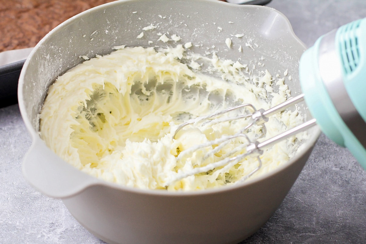 Whipping cream cheese mixture in a grey bowl.
