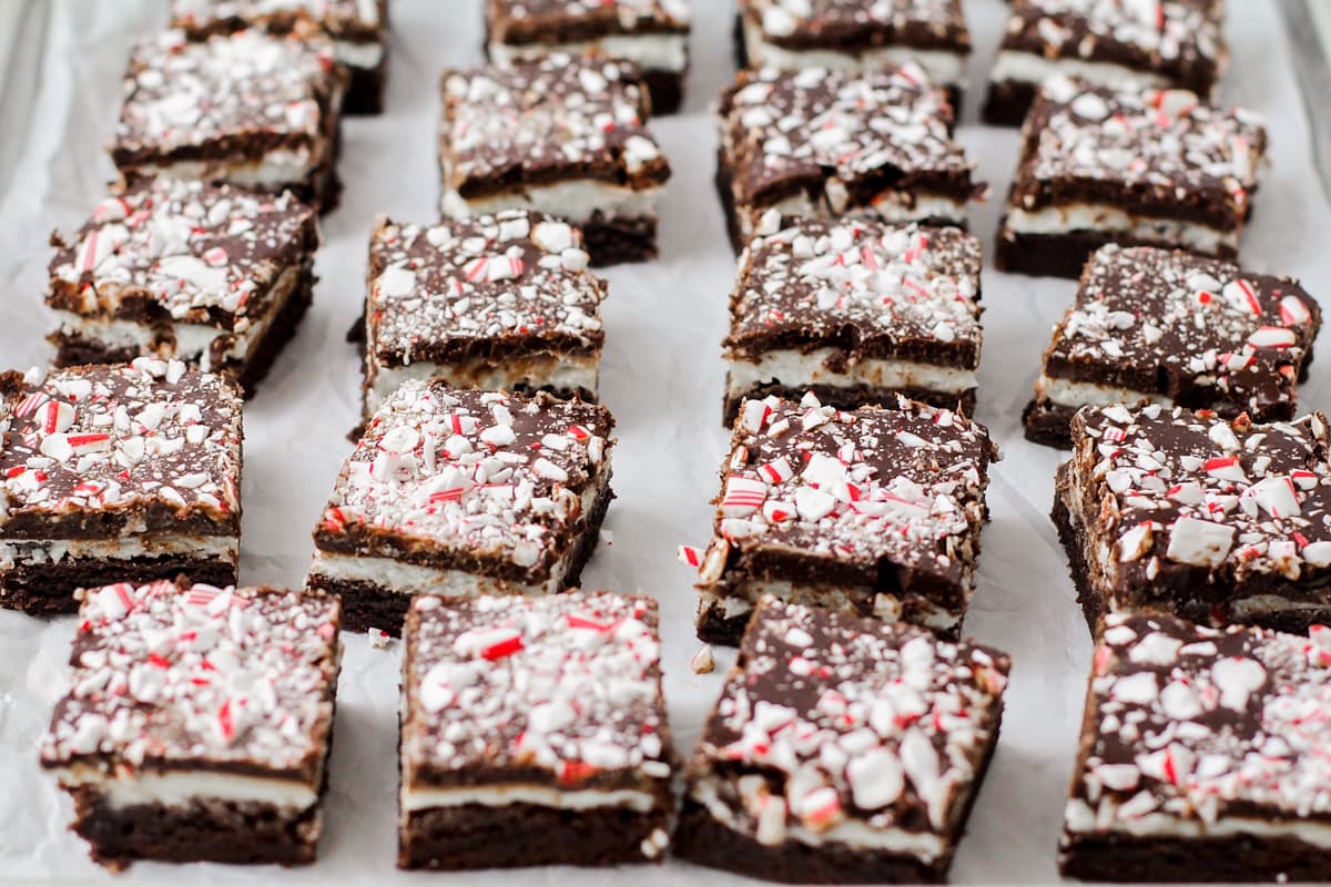 Cut peppermint brownies on a lined baking sheet.