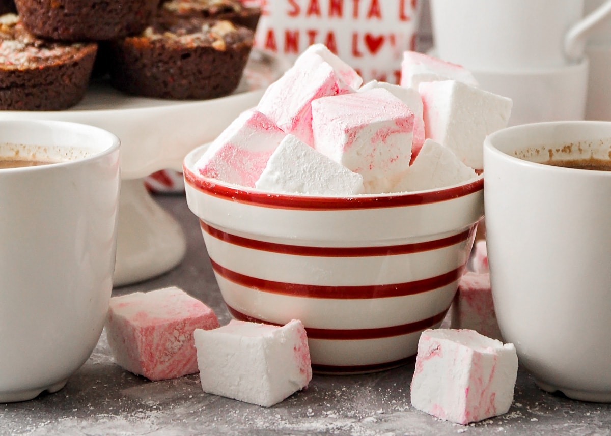 Red and white bowl filled with peppermint marshmallows.