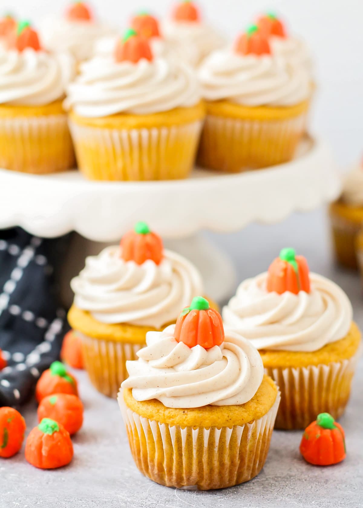 Easy pumpkin cupcakes with mallow pumpkins scattered around.