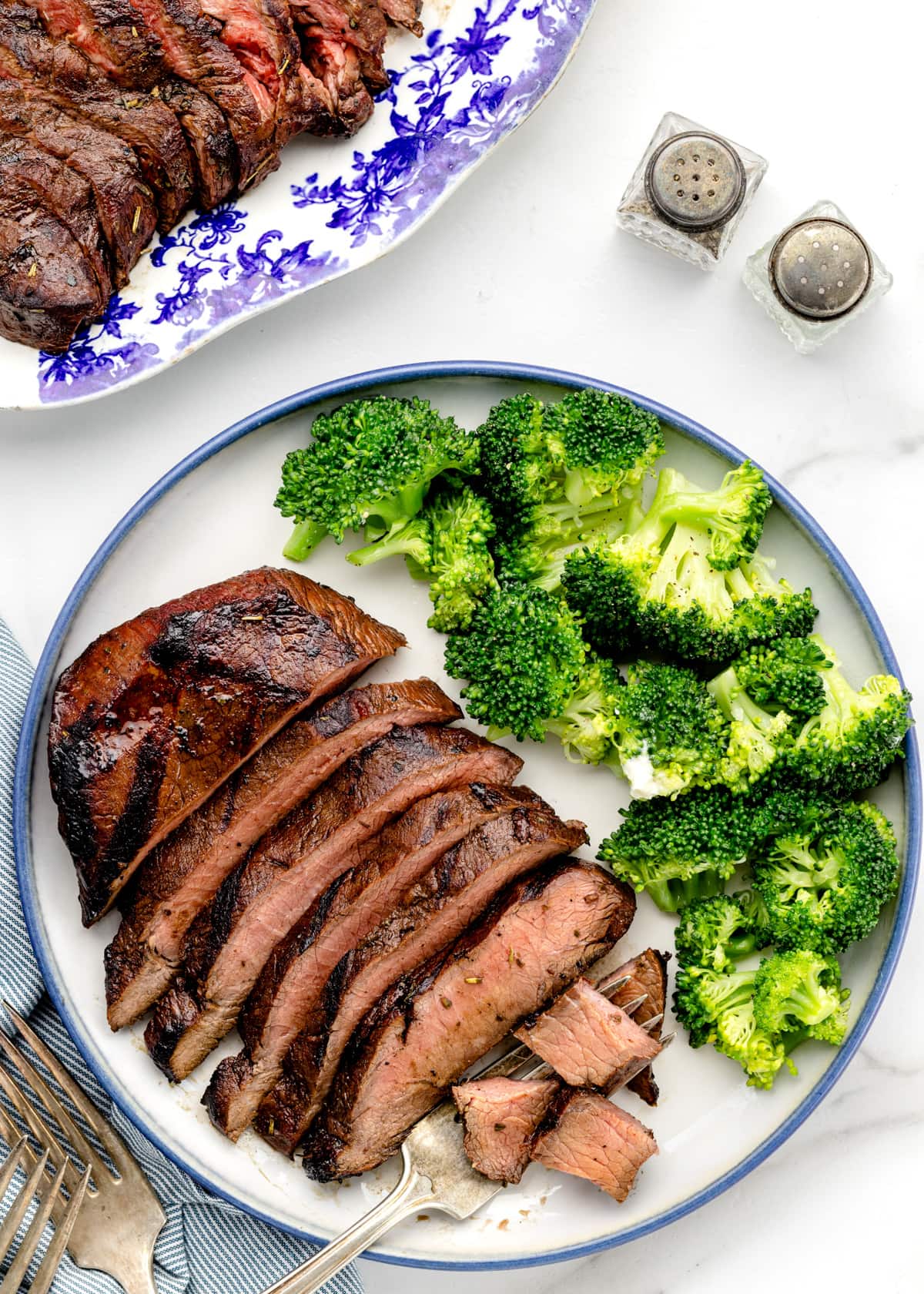 Steak marinade used on a sliced steak served with broccoli.