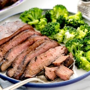 Easy steak marinade flavored steak sliced and served with broccoli.