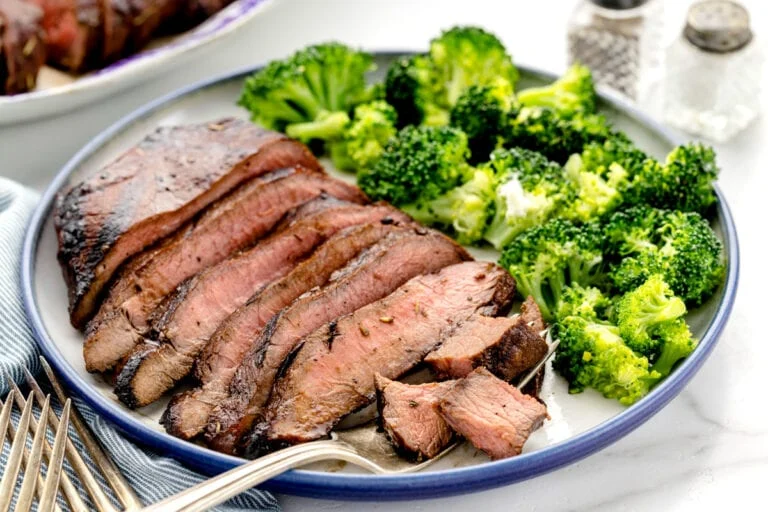 Easy steak marinade flavored steak sliced and served with broccoli.