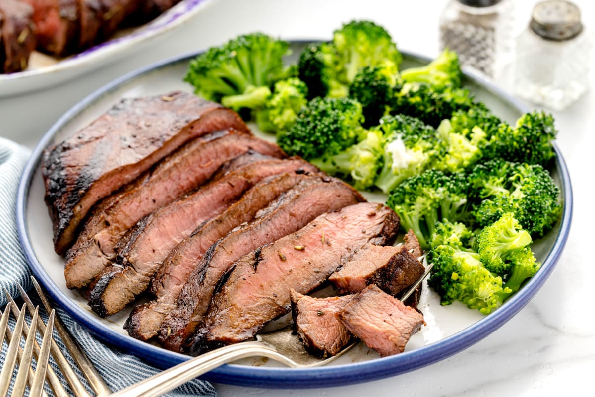 Steak marinade used on a slice steak served with broccoli.