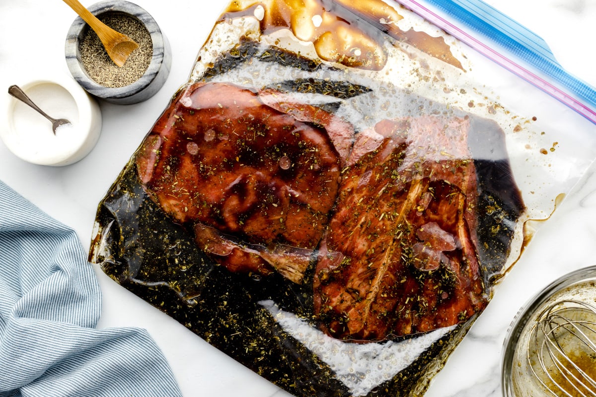 Steak marinating in a ziploc bag.