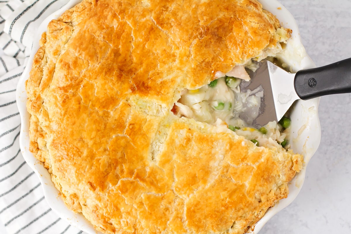A chicken pot pie with a slice missing.