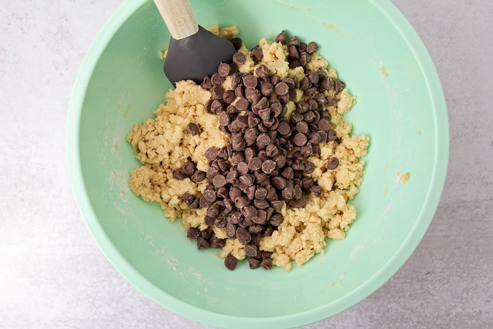 Cookie cake ingredients mixed in bowl.