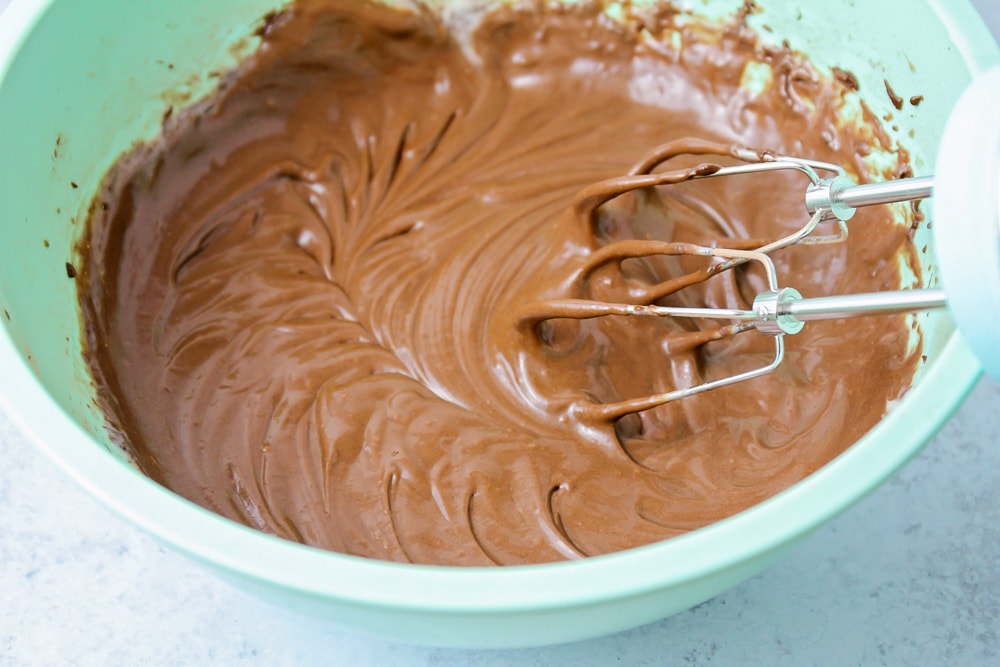 Whipping up chocolate cupcake batter in a mint bowl.