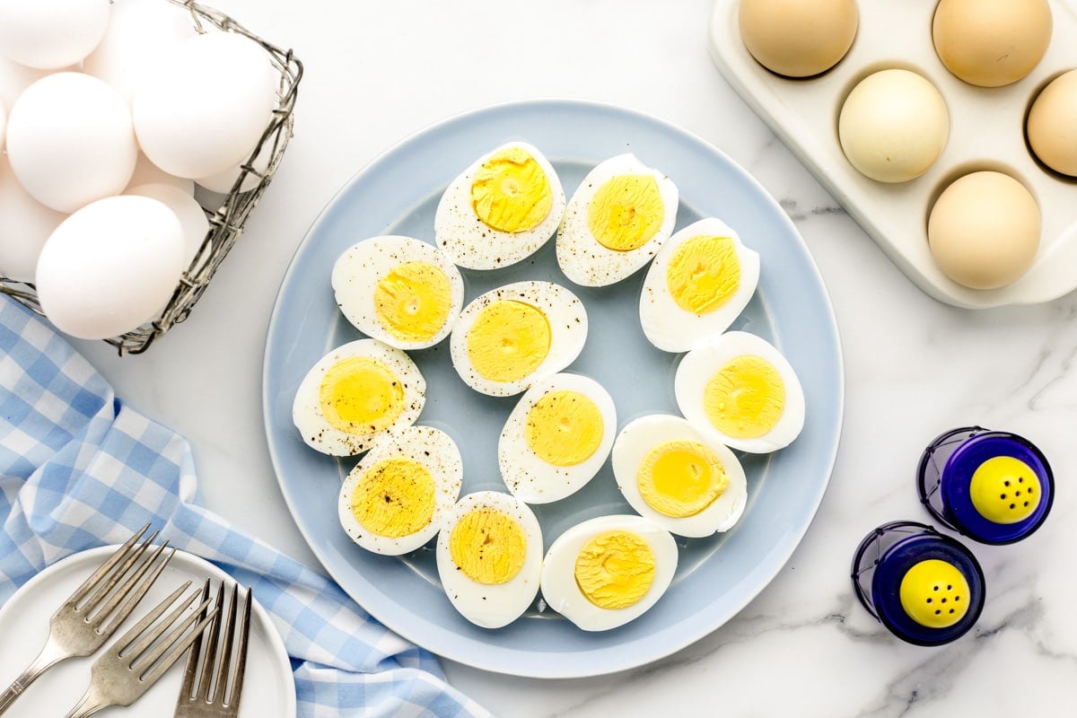 How to Boil Eggs tutorial - hard boiled eggs cut in half on plate.