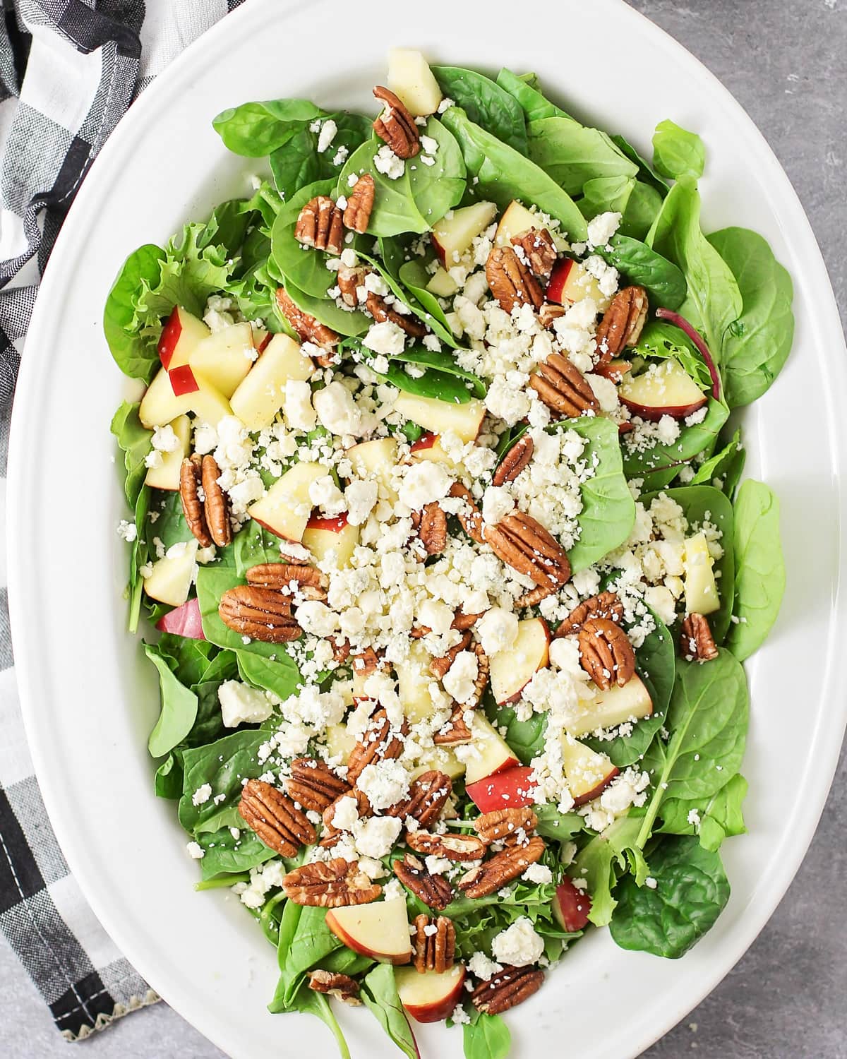 Top view of a platter filled wtih apple pecan salad.