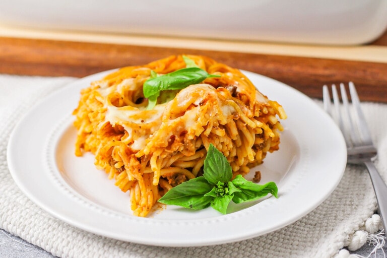 Baked spaghetti served on a white plate.